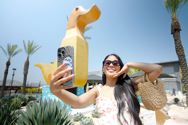 A young woman takes a selfie at The Shops at Dos Lagos